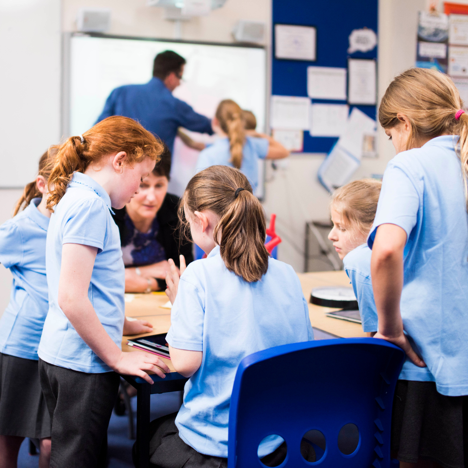 A few primary school classroom with students working together round a table